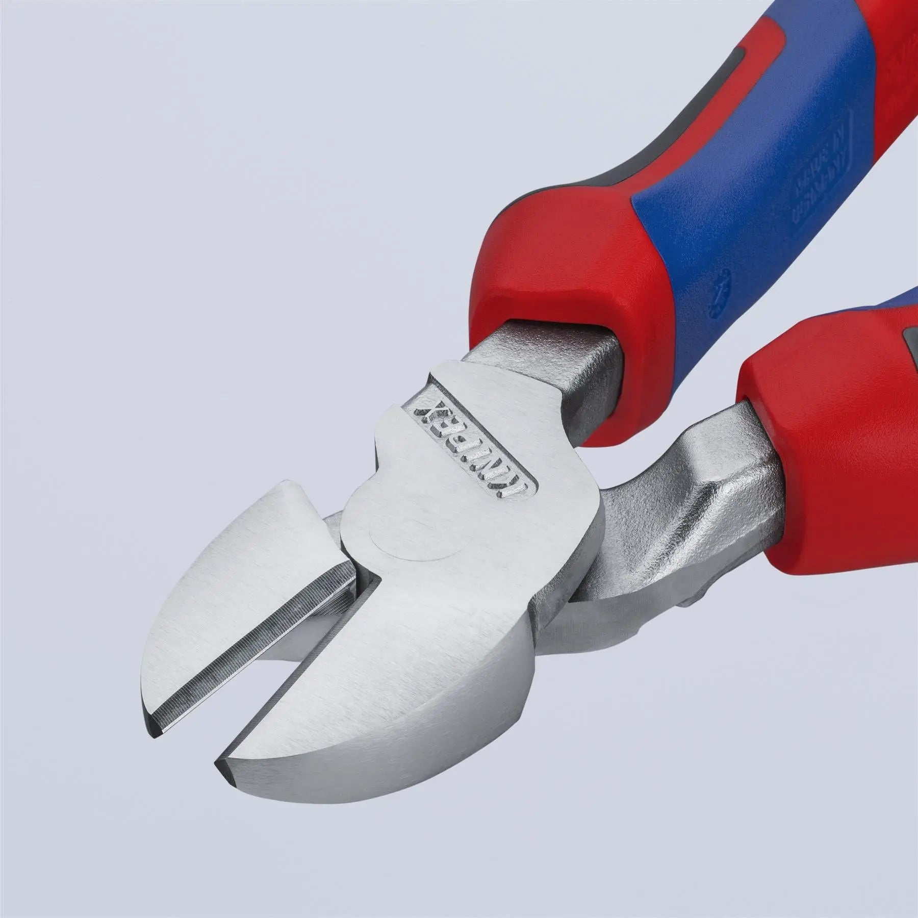 Pair of wire cutters with red and blue handles on a light gray background